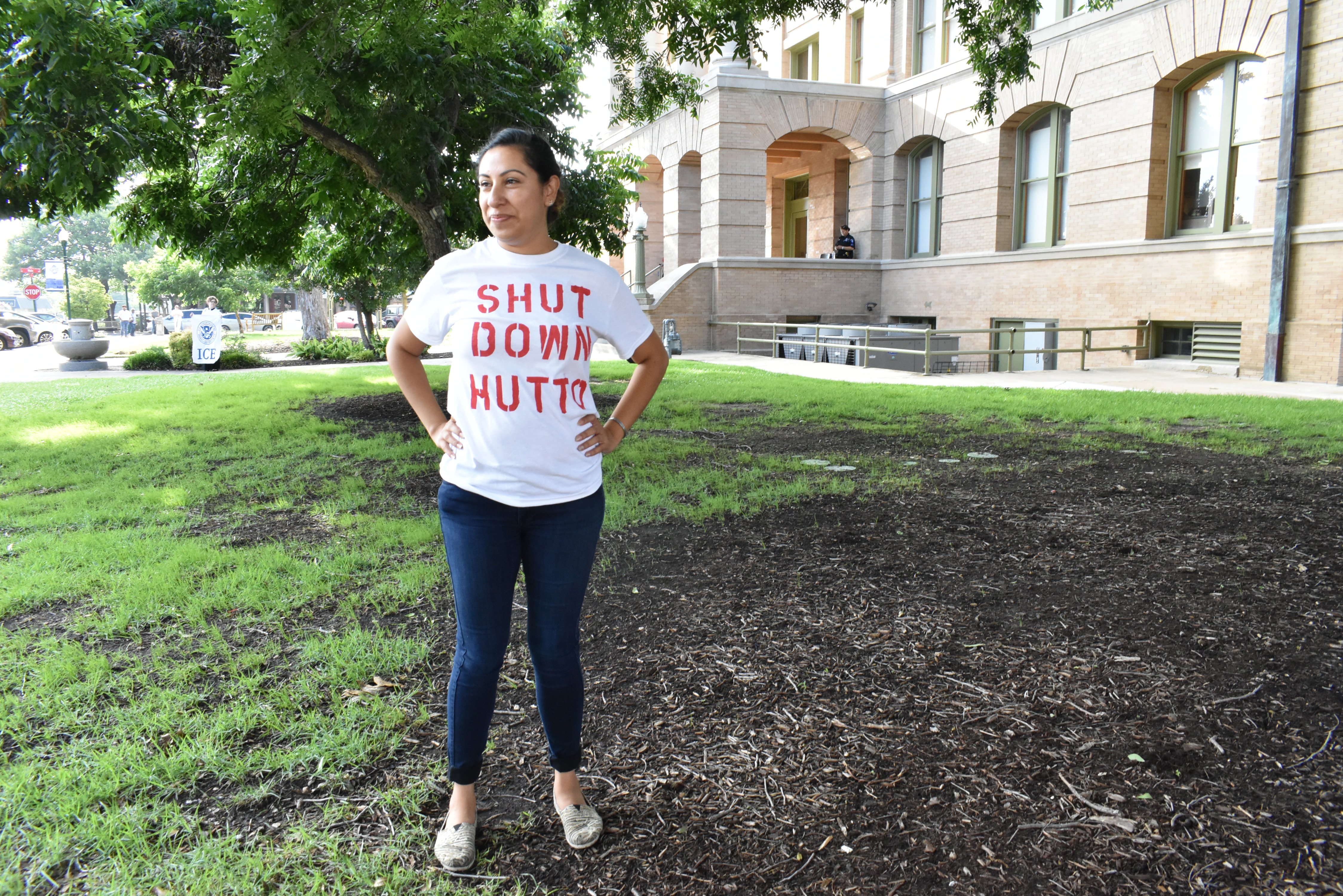 A woman wearing a t-shirt which says "Shut down Hutto"