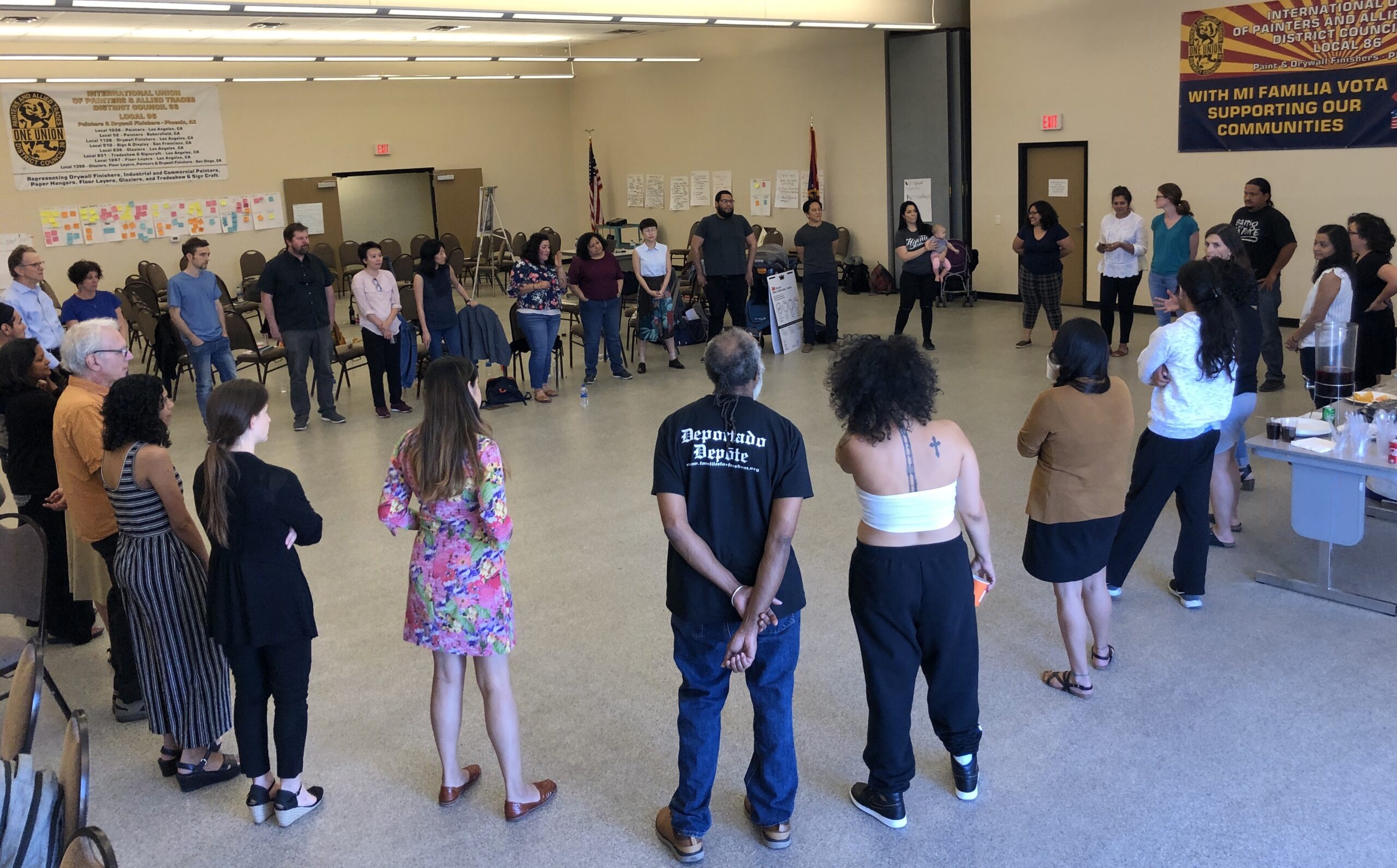 A group of people standing around in a circle 