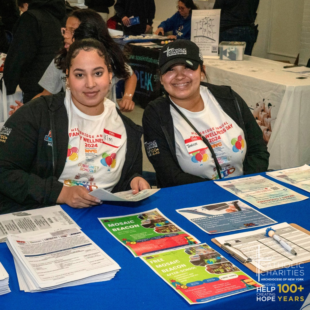 CCNY two women at a desk with flyers