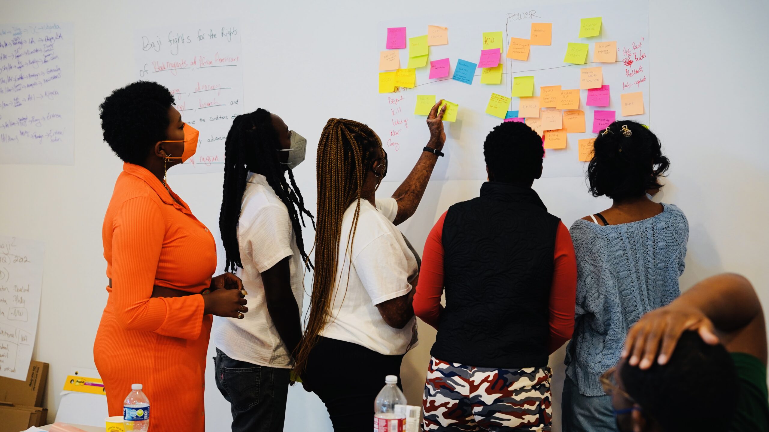 Women looking at a board with sticky notes