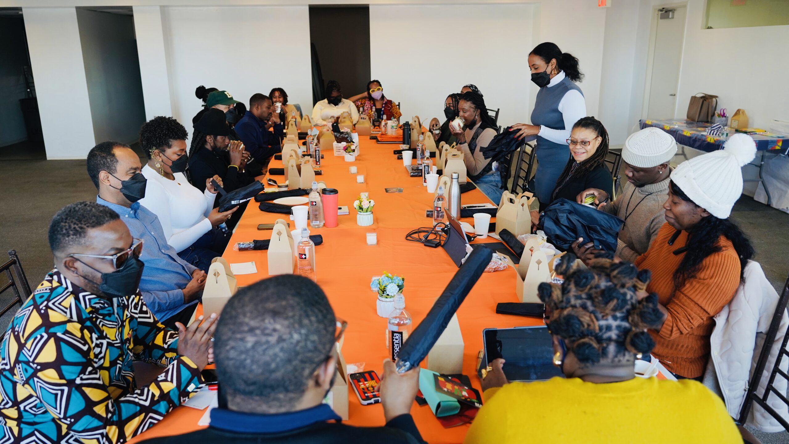 A group of people gathered around a table talking